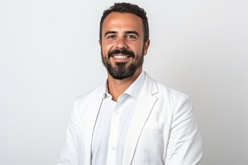 Fototapeta premium Portrait of handsome bearded Indian man smiling and looking at camera.