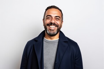 Portrait of a happy latin man smiling on a white background