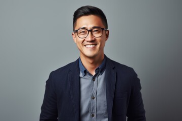 Portrait of a smiling young asian businessman in eyeglasses