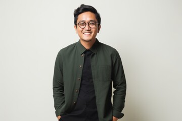 Fototapeta premium Portrait of a happy young asian man with eyeglasses