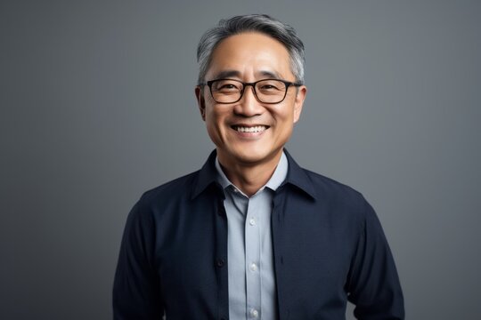 Portrait of smiling asian senior business man in eyeglasses