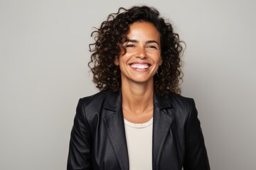 Portrait of a smiling african american businesswoman standing isolated over gray background