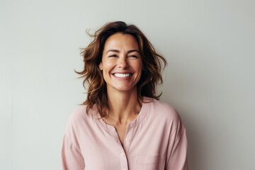 Portrait of a happy young woman smiling and looking at camera.