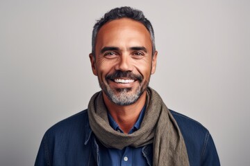 Fototapeta premium Portrait of a smiling middle-aged man in a blue shirt and scarf