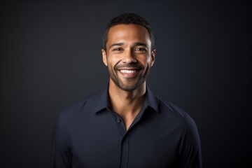 Portrait of a smiling african american man on black background