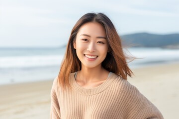 Portrait of a beautiful young asian woman smiling on the beach
