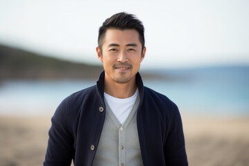 Portrait of handsome asian man on the beach at the seaside