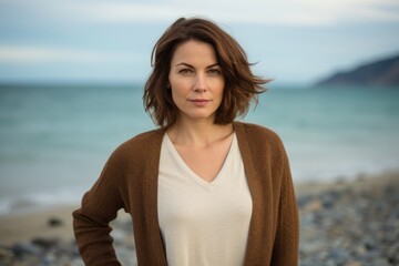 Portrait of a beautiful woman on the beach in autumn season.