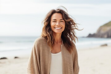 Portrait of a smiling young woman with long hair at the beach