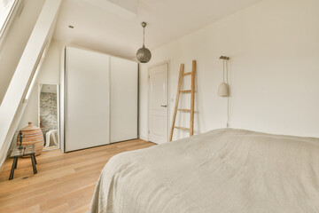 a bedroom with white walls and wood flooring in the fore - image was taken from an insic window