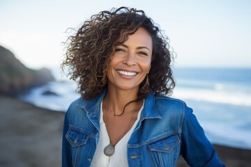 Portrait of smiling woman standing on the beach on a sunny day