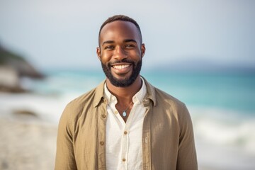 Portrait of smiling man standing on the beach at the day time