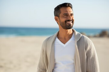 Portrait of a handsome man smiling at the beach on a sunny day