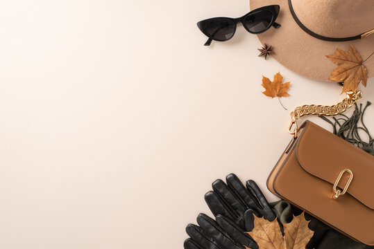 Perfect fall fashion accessories for warmth and style: handbag, felt hat, gloves and scarf and sunglasses. Top view image on white isolated background, offering copy-space for text or promotion
