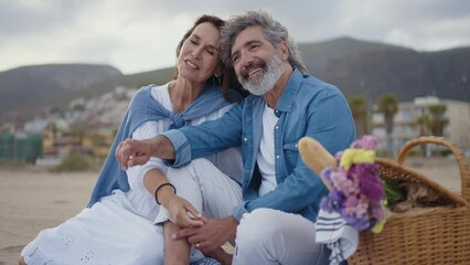 Cinematic video of a senior couple spending time on the beach and making different activities near the ocean. Romantic concept about a man and a woman in love. Lifestyle in the seniority age