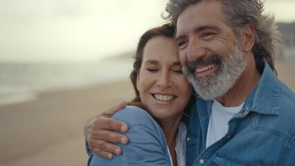 Cinematic video of a senior couple spending time on the beach and making different activities near the ocean. Romantic concept about a man and a woman in love. Lifestyle in the seniority age - Powered by Adobe