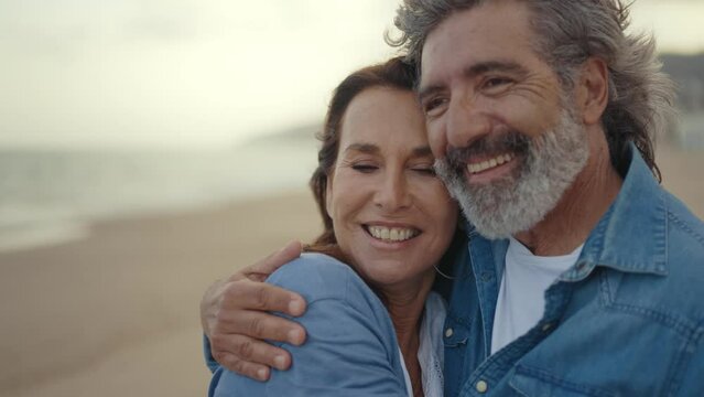 Cinematic video of a senior couple spending time on the beach and making different activities near the ocean. Romantic concept about a man and a woman in love. Lifestyle in the seniority age