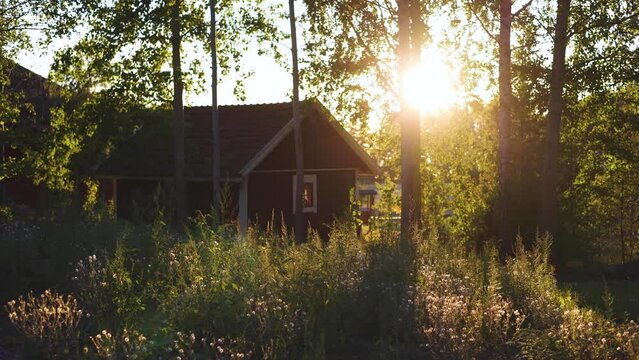 View of classical finnish landscape with traditional wooden red cabin cottage houses and camping site, Uusimaa, Southern Finland in a summer sunny day