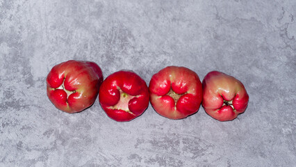 Arranged red wax apple or rose apple (Jambu air). Isolated on gray background.