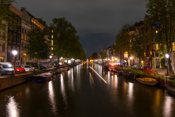 Parked Cars and Boats on Amsterdam Canal at Night