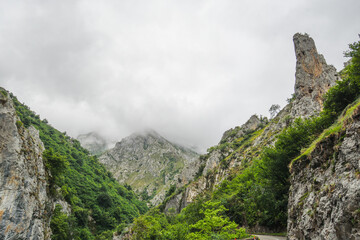 Limestone mountain between the fog in the Los Beyos gorge