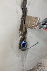 Concrete wall cutting and concealed wiring during electrical work on interior decoration