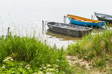 Wooden fishing boats on the river bank in a fishing village - industrial fishing and water walks