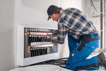 Underfloor heating. Installation of pipes to the Heating circuit distributor for underfloor heating...
