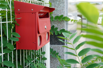 red mailbox on the fence, on the street background