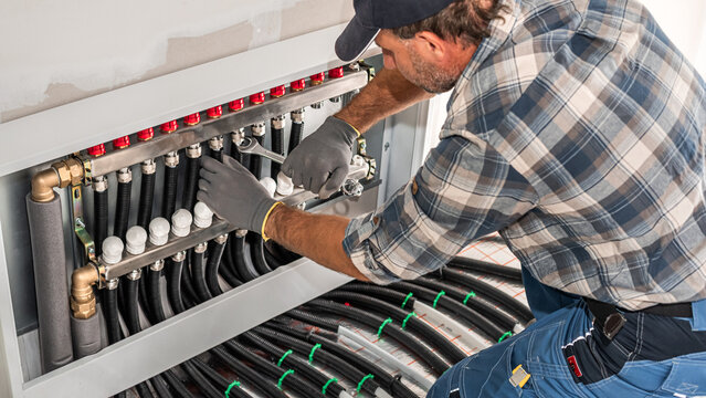Underfloor heating. Installation of pipes to the Heating circuit distributor for underfloor heating including ball valves, 12 heating circuits. 