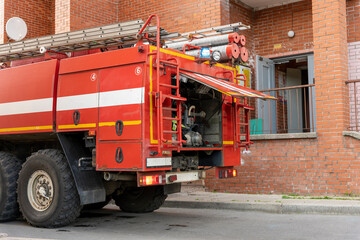 fire truck with a siren on call in the courtyard of the city