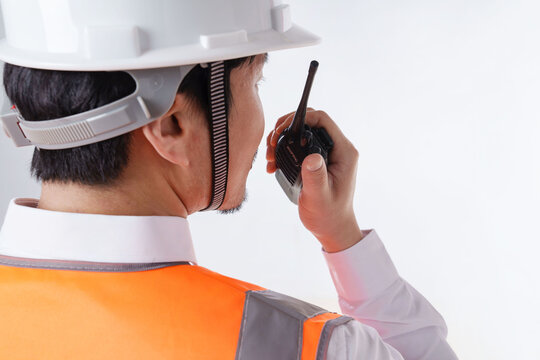 Construction works inspector using walkie-talkie