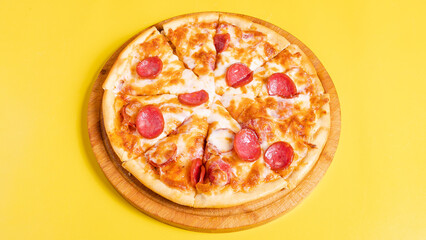 Pepperoni pizza isolated on yellow