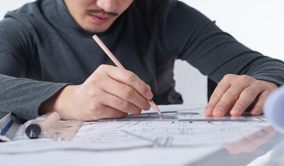 Close-up of an architectural designer who draws drawings