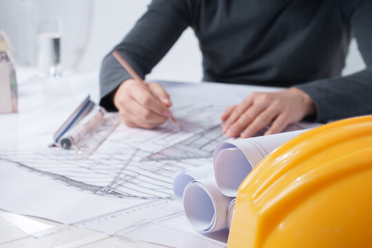 Close-up of an architectural designer who draws drawings