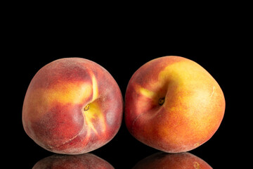 Two ripe organic peaches, macro, isolated on black background.