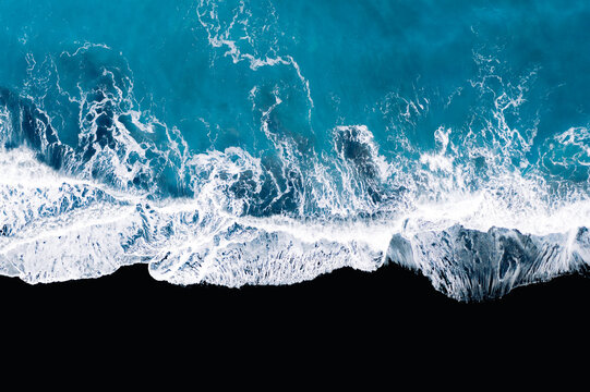 Aerial Photography of Waves crashing on a black sand beach in Iceland
