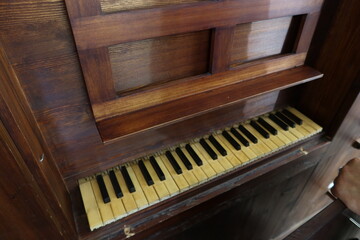 Fototapeta na wymiar Castaño del Robledo, Huelva, Spain, June 22, 2023: Keyboard of the 18th century pipe organ from the Santiago el Mayor church in Castano del Robledo, Huelva, Spain