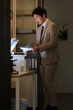 Middle-aged business man working overtime in office