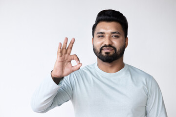 South Asian man pointing up approving ok hand gesture, concept of good, yes, acceptance, success, agreement, like, satisfaction, all correct