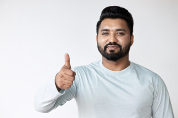 South Asian man pointing up approving thumb up hand gesture, concept of good, yes, acceptance,...