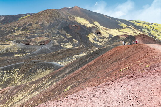 Walking to the Mount Etna volcano on a tourist tour