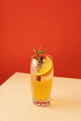 Fresh cocktail with orange, ice and herbs on the  table. Refreshing drink on a hot summer day. Ice tea. Sangria or punch in a glass