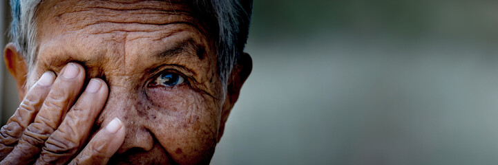 Old women cover her eye with her hand for eye testing in panoramic view use for medical and...