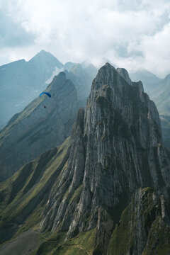 Paraglider at Schäfler mountain landscape with clouds in Switzerland