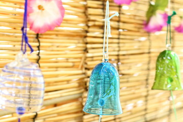 Colorful Japanese wind chimes with bamboo blind background