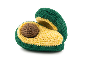 Two halves of an artificial avocado with a bone, knitted from thick yarn