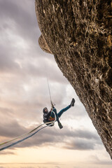 boy climbing on the mountain, boy rappelling on the mountain, enjoy outdoors