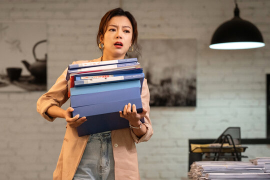 Youth career women hold a stack of folders