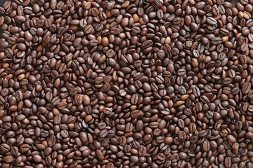 Top view of background representing halves of dark brown coffee beans. Roasted coffee beans, copy space